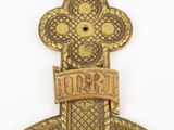 a close up of a metal object with a cross on it