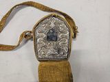 an antique silver and gold purse with a blue stone in the center
