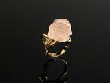 a close up of a gold ring with a rose on it