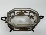 a silver plate with a bird on it
