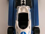 a blue and white race car on display on a table