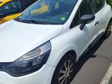 a white car parked in a parking lot next to a yellow car