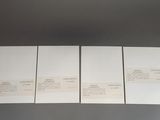 four pieces of white paper sitting on top of a table