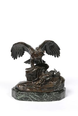 bronze statue of a bird on a rock on a white background