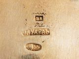 an image of a close up of a silver plate with a clock on it