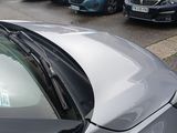 cars parked on the side of the road in a parking lot