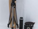 a tripod, camera, and other items on a white background