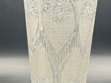 a glass vase with a design on it on a table