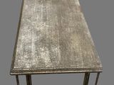 an old wooden table with a metal frame on top of it