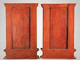 pair of antique red painted wooden doors with a white background
