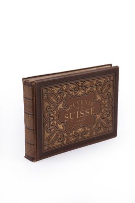 an old book sitting on top of a white surface