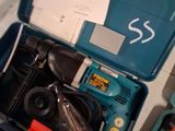 a blue tool box with tools in it on a table