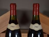 two bottles of wine sitting next to each other on a table