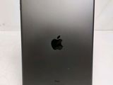 an apple ipad is sitting on a stand on a white surface