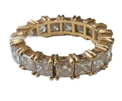 a close up of a gold ring with white diamonds on it