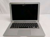 a silver laptop computer sitting on a white surface