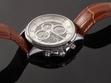 an image of a close up of a watch on a black surface