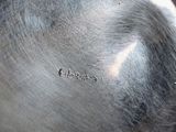 a silver pot with a lid sitting on a table