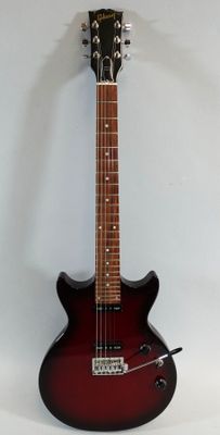 an electric guitar is sitting on a stand against a white wall
