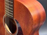 a close up of an acoustic guitar on a black background