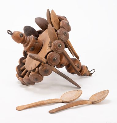 a wooden toy that is sitting next to some wooden spoons