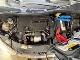 the engine of a car with a bunch of tools in it