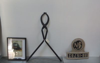 a clock on the wall next to a picture and a clock on the floor