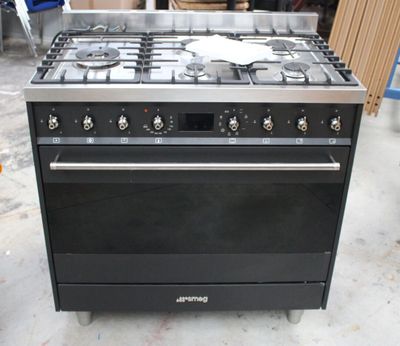 an image of a black stove top oven in a garage