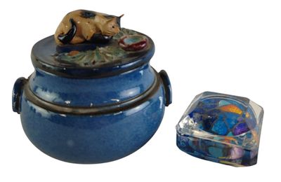 a blue container with a bear on it and a glass container with a lid