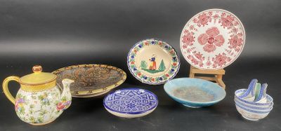 many different types of dishes and bowls on the table