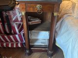 une petite table sur laquelle est posée une valise, à côté d'un lit