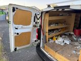 a van that has a bunch of items in the back of it