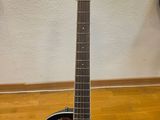 an acoustic guitar sitting on top of a wooden floor next to a wall