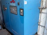 a blue machine that is sitting outside of a building
