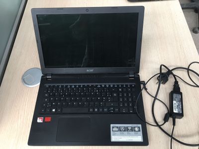 a laptop that is sitting on a desk with a charger