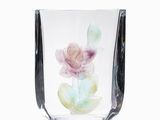 a glass vase with a flower inside of it