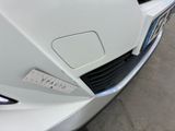 a close up of a white car with a number plate on it