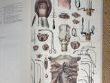 an open book with illustrations of medical equipment on it