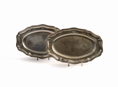 pair of silver plated trays on stands on a white surface