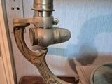 a metal pipe that is on top of a wooden table