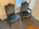 two chairs that are sitting next to each other in a room