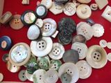a lot of buttons that are on a red table