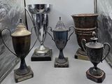 many silver trophies on display in a display case