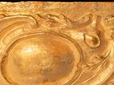 a gold plate with a design on it