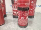 several red fire extinguisors are lined up on a table