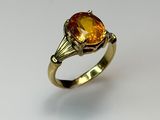 a close up of a gold ring with a citrine stone