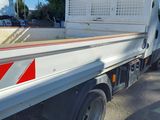 a white truck with a red stripe on the back