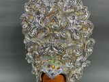 a close up of a hat made out of silver and gold beads