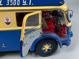 a toy bus that is sitting on a white surface