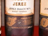 three bottles of wine that are on a red table